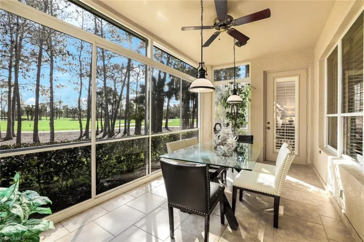 Sunroom featuring view of golf course