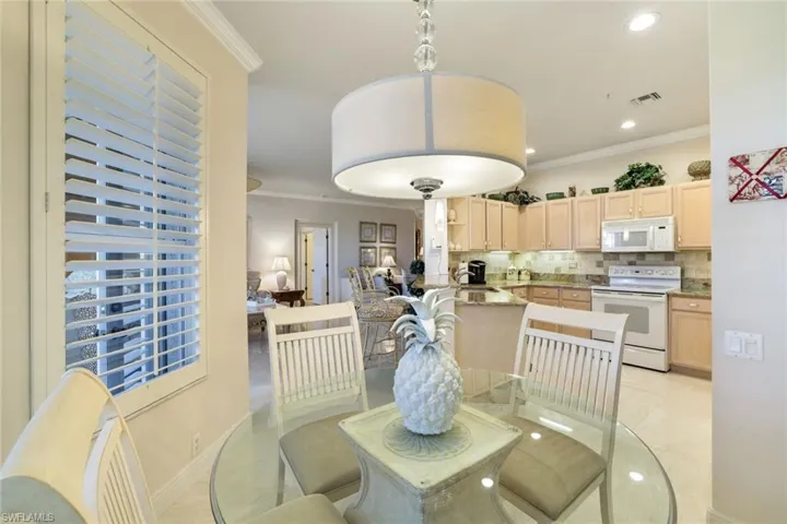 Dining room featuring crown molding and recessed lighting