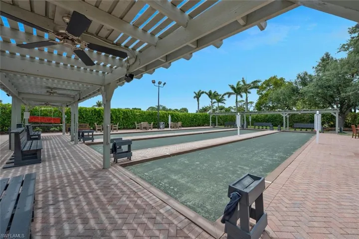 View of community featuring a bocce ball area and a pergola