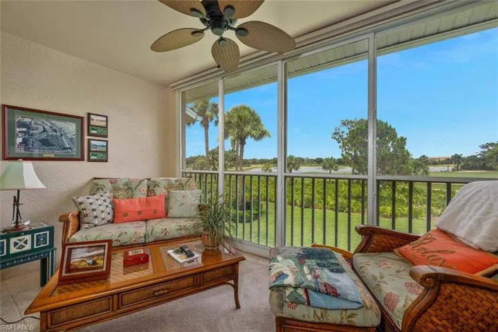 Sunroom with a ceiling fan and an outdoor living space