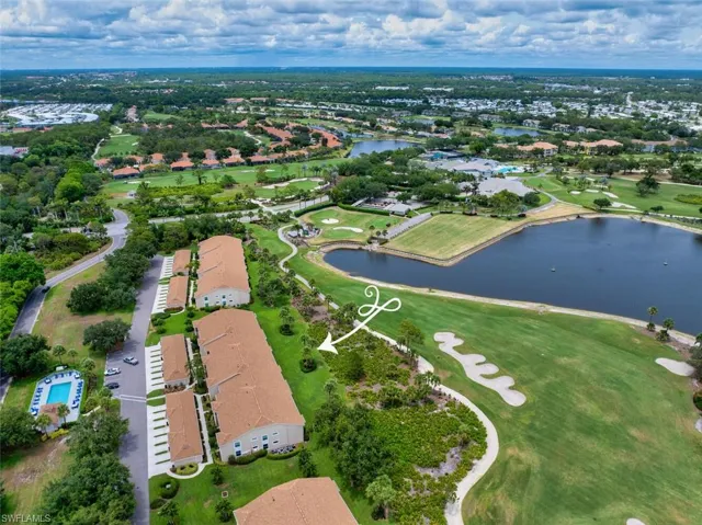 Aerial perspective of suburban area with a nearby body of water and a golf club