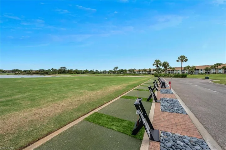 Surrounding community with a yard, a bocce ball area, a water view, and golf course view