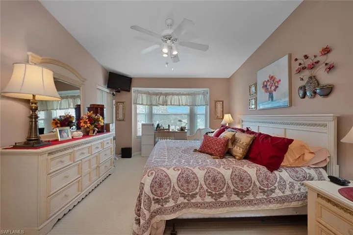 Bedroom featuring light colored carpet and a ceiling fan