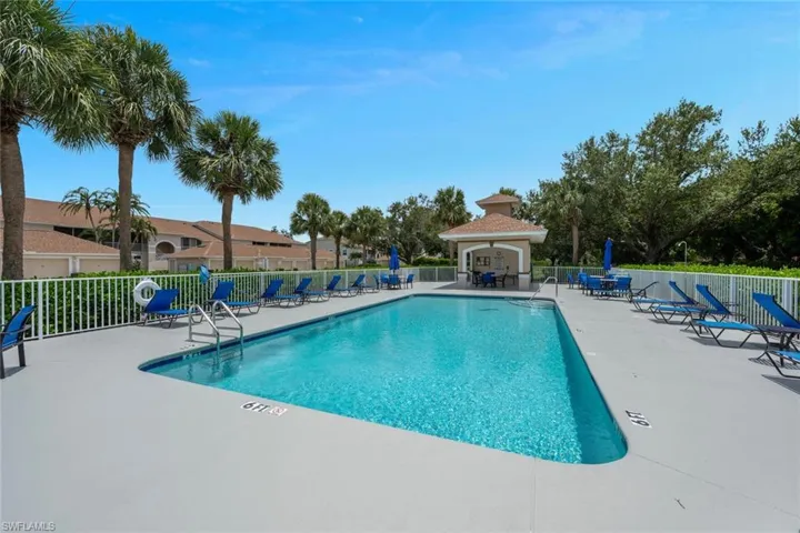 Community pool with a patio