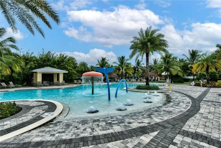 Community pool with a patio, a gazebo, and a water play area