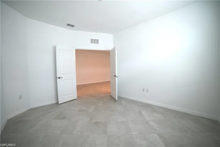 Unfurnished room with baseboards