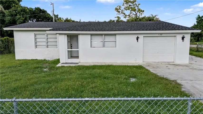View of front of house featuring driveway, roof with shingles, an attached garage, and stucco siding