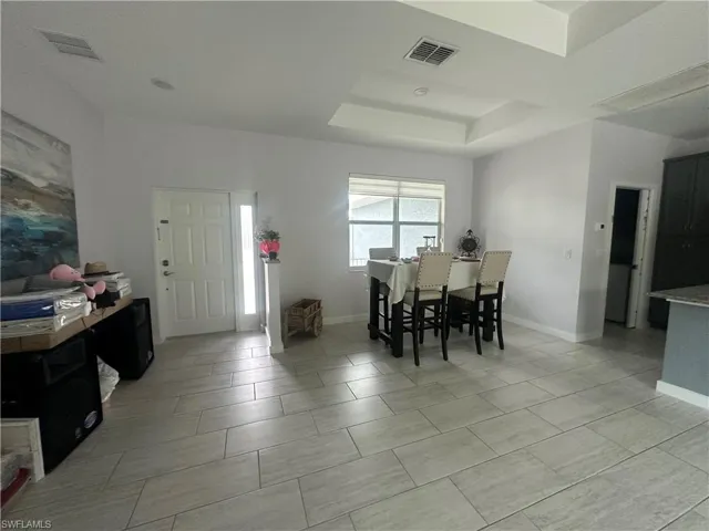 Dining area featuring a tray ceiling