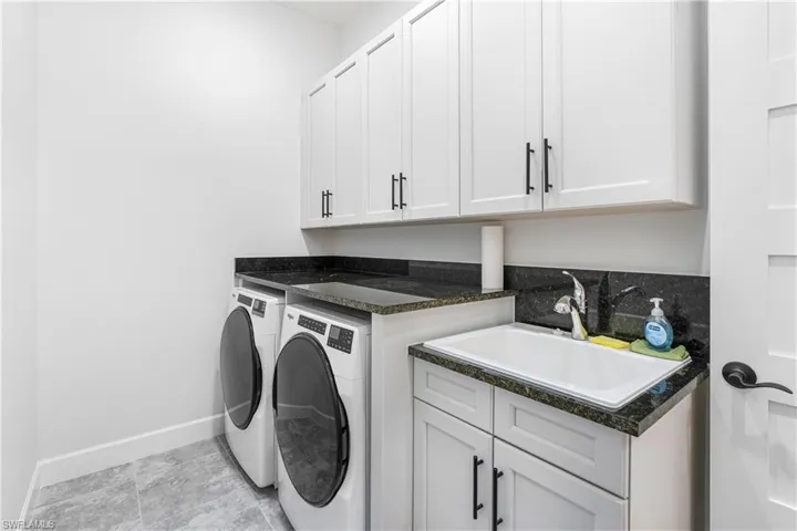 Laundry area with cabinet space and independent washer and dryer