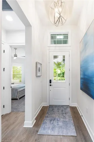 Entrance foyer featuring dark wood finished floors and a chandelier