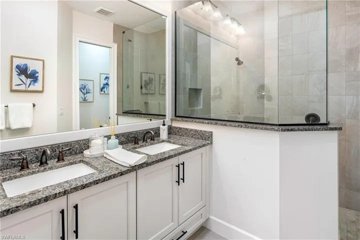 Full bath with a walk in shower and double vanity