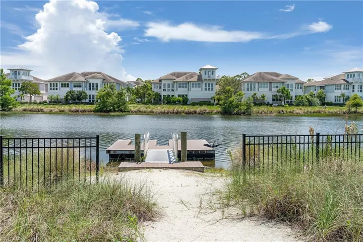 Water view with nearby suburban area and a floating dock