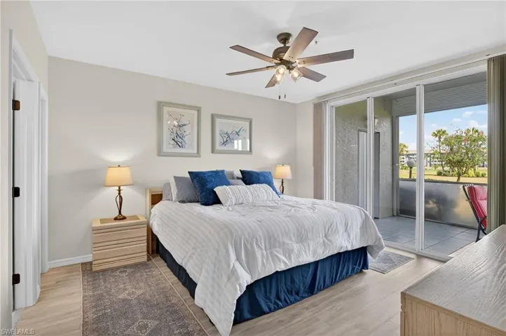 Bedroom with access to exterior, light wood finished floors, and ceiling fan