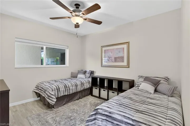 Bedroom with light wood finished floors and a ceiling fan