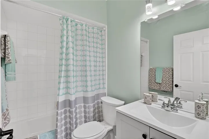 Full bath with vanity and shower / tub combo with curtain