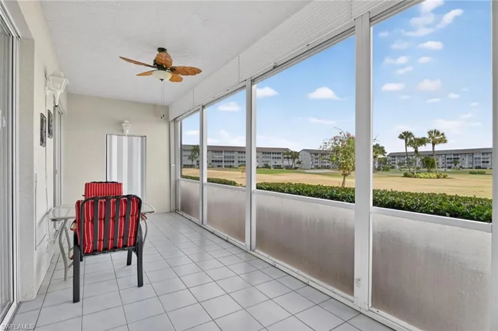 Sunroom featuring a ceiling fan