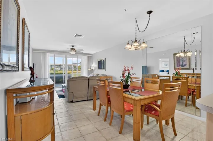 Dining area featuring ceiling fan, healthy amount of natural light, and light tile patterned flooring