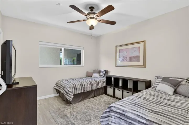 Bedroom with light wood finished floors and ceiling fan