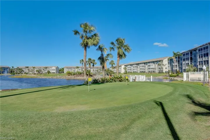 View of community with a water view, golf course view, and a putting green