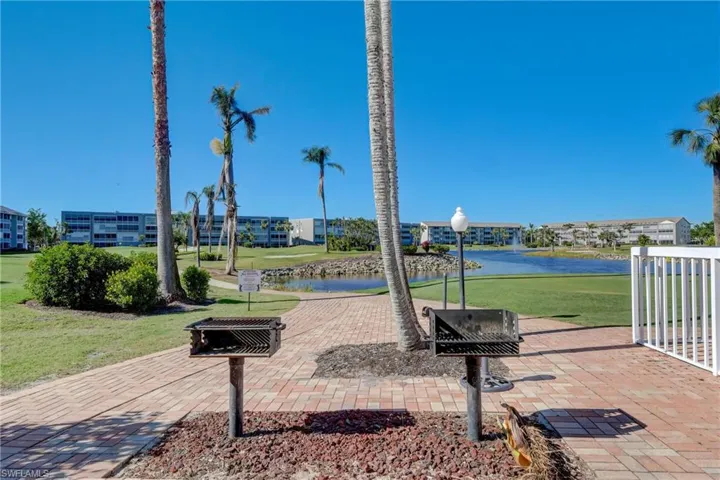 View of home's community with a water view and a patio
