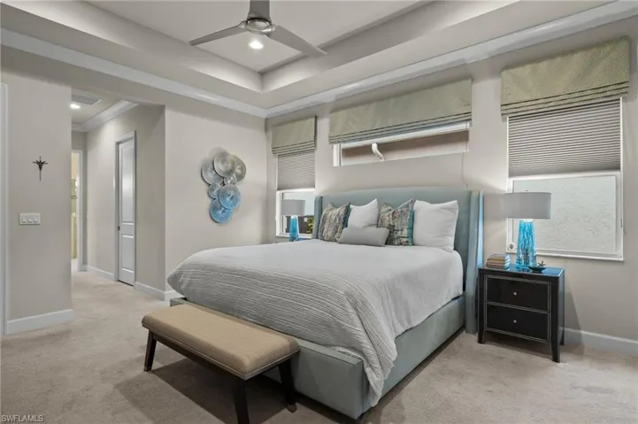 Carpeted Master bedroom with ornamental Crown molding, ceiling fan, Custom Roman shades