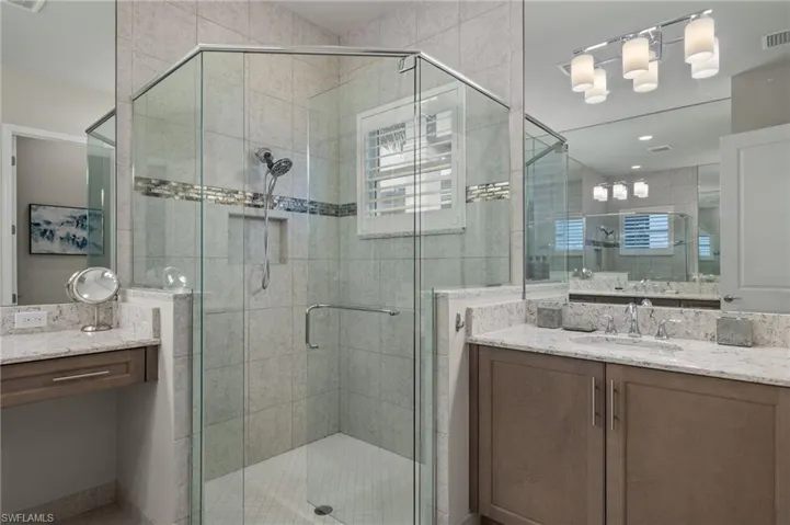 Bathroom with frameless shower door and vanity
