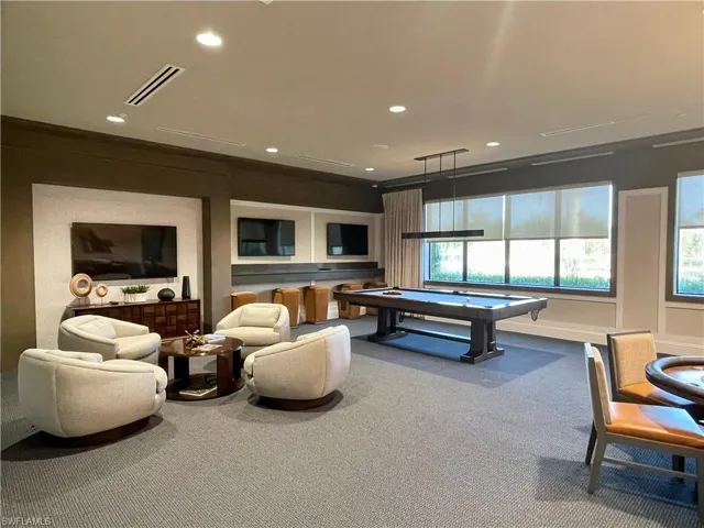Game room with billiards, Casino tables, TV's, plenty of natural light, crown molding, and carpet floors