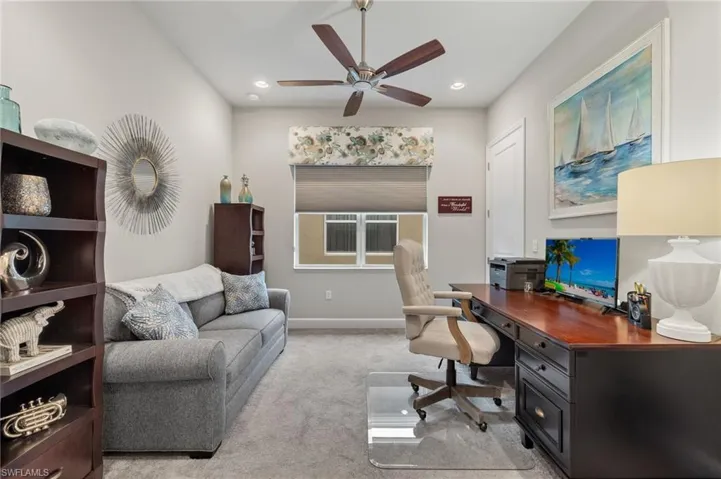 Spacious Office area/third bedroom with light colored carpet and ceiling fan