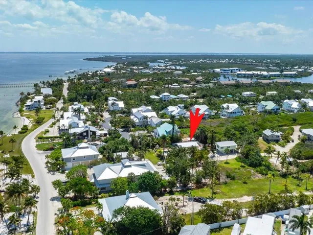Birds eye view of property with a water view