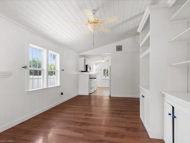 Unfurnished living room with wooden ceiling, dark hardwood / wood-style flooring, ceiling fan, and lofted ceiling