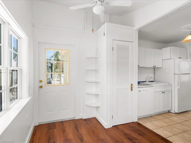 Doorway to outside featuring sink, ceiling fan, and tile floors
