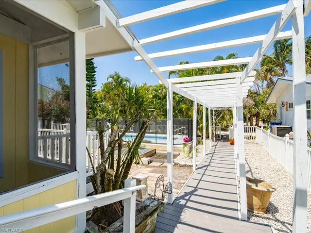Wooden deck with a pergola and a fenced in pool
