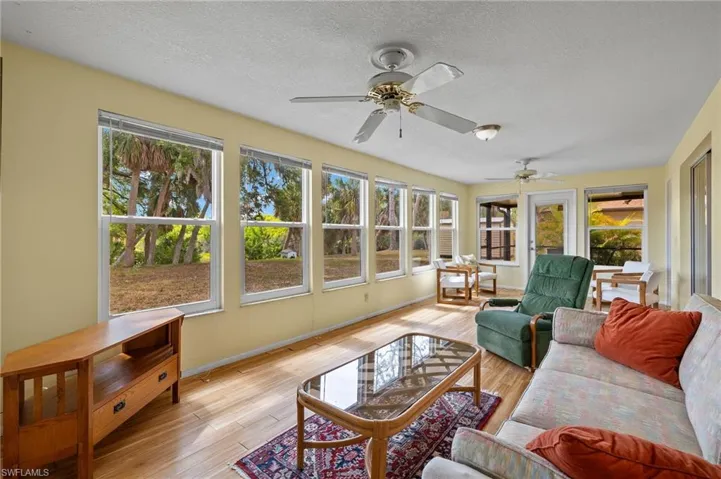 Sunroom with ceiling fan and a wealth of natural light