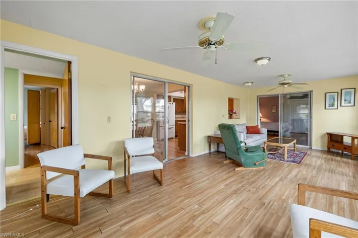 Living room featuring light wood-type flooring and ceiling fan
