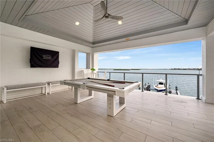 Recreation room with wood ceiling, pool table, and light hardwood / wood-style flooring