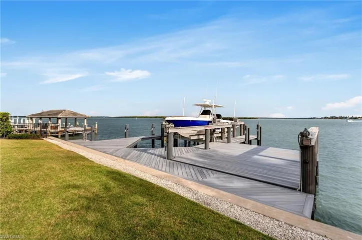 Dock area featuring a water view and a yard