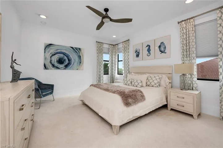 Carpeted bedroom with ceiling fan
