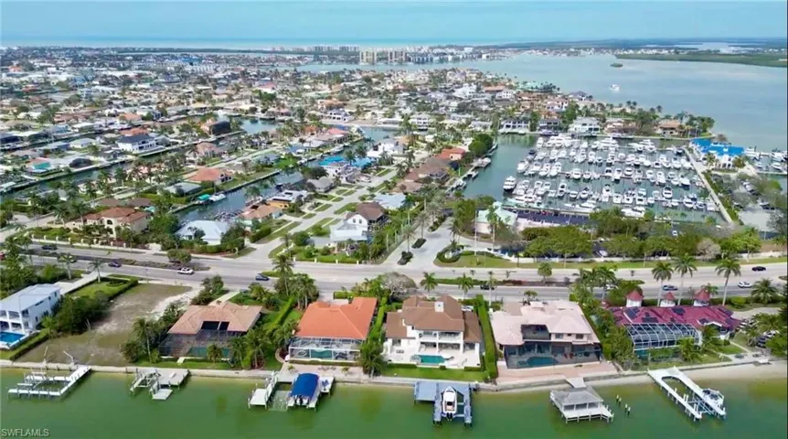 Birds eye view of property with a water view