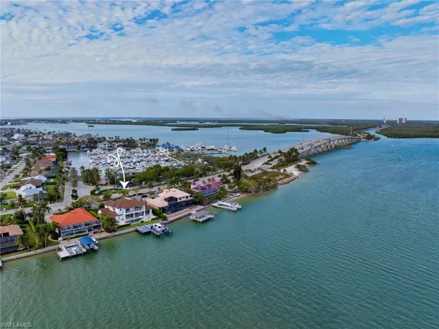Birds eye view of property with a water view