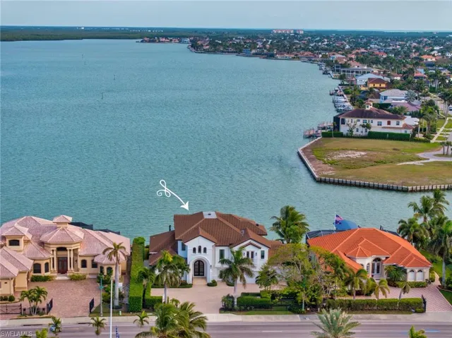Birds eye view of property with a water view