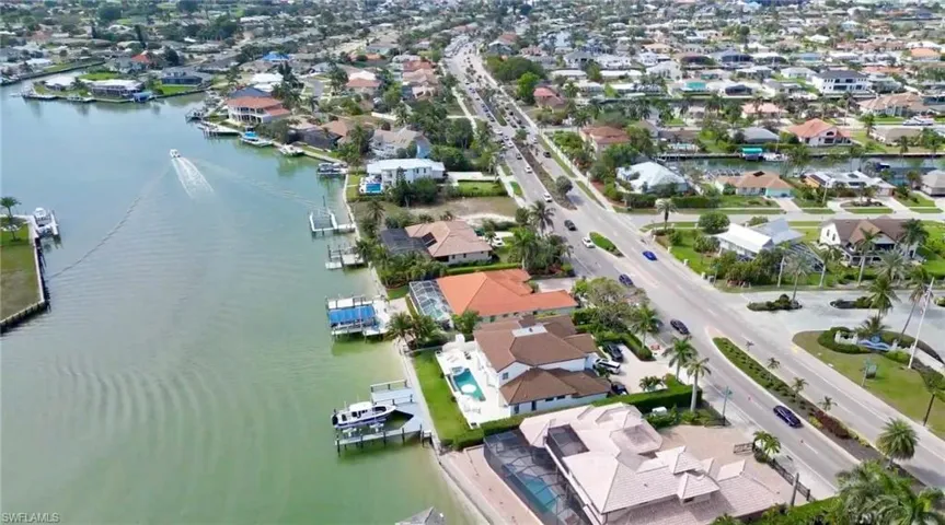 Birds eye view of property with a water view