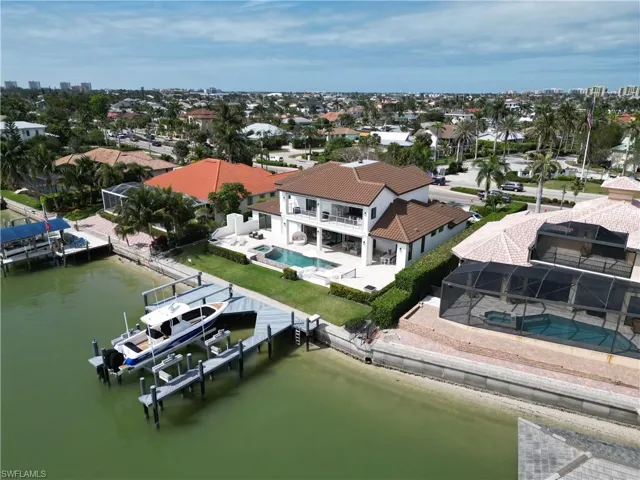 Birds eye view of property with a water view
