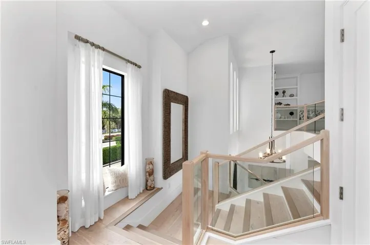 Staircase featuring hardwood / wood-style floors