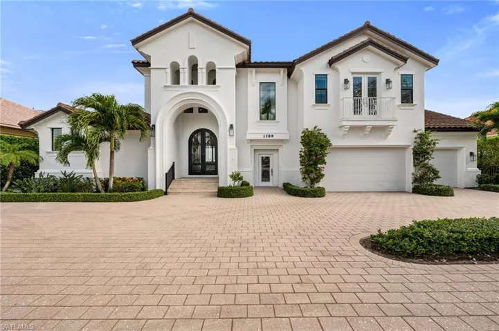 Mediterranean / spanish house with a garage and french doors