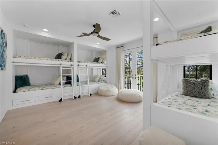 Bedroom with ceiling fan, access to exterior, french doors, and light hardwood / wood-style flooring