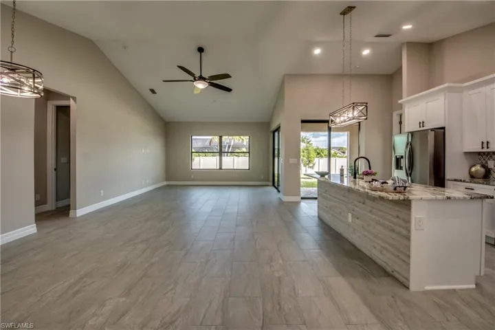 Don't miss the beautiful Shiplap on the front of the Island in the kitchen !  So many personal touches.  Porcelan Plank tile throughout the home.  High Ceilings !!