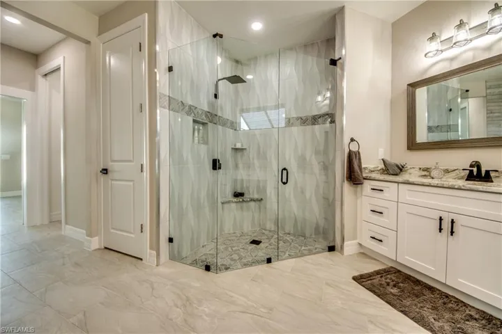 View of Master Shower with Frameless Walls and Rain Shower Head, the Door to the left leads to toilet area