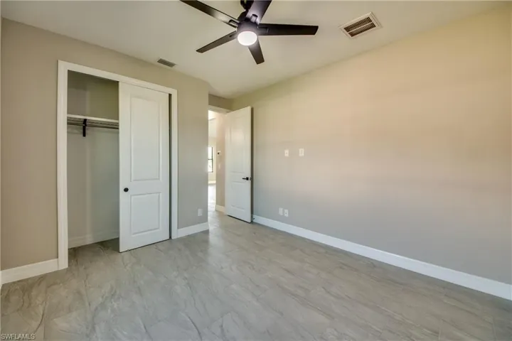 Bedroom #3 All Bedrooms have a ceiling fan and Wood Shelf closets