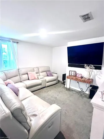 Living area with carpet and baseboards