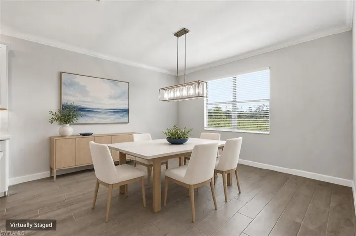 Dining area featuring wood-finish flooring and a rectangular window with blinds